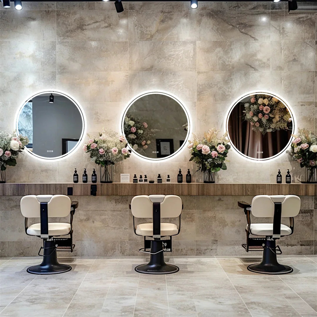 Three round LED bathroom mirrors in a hair salon salon setting