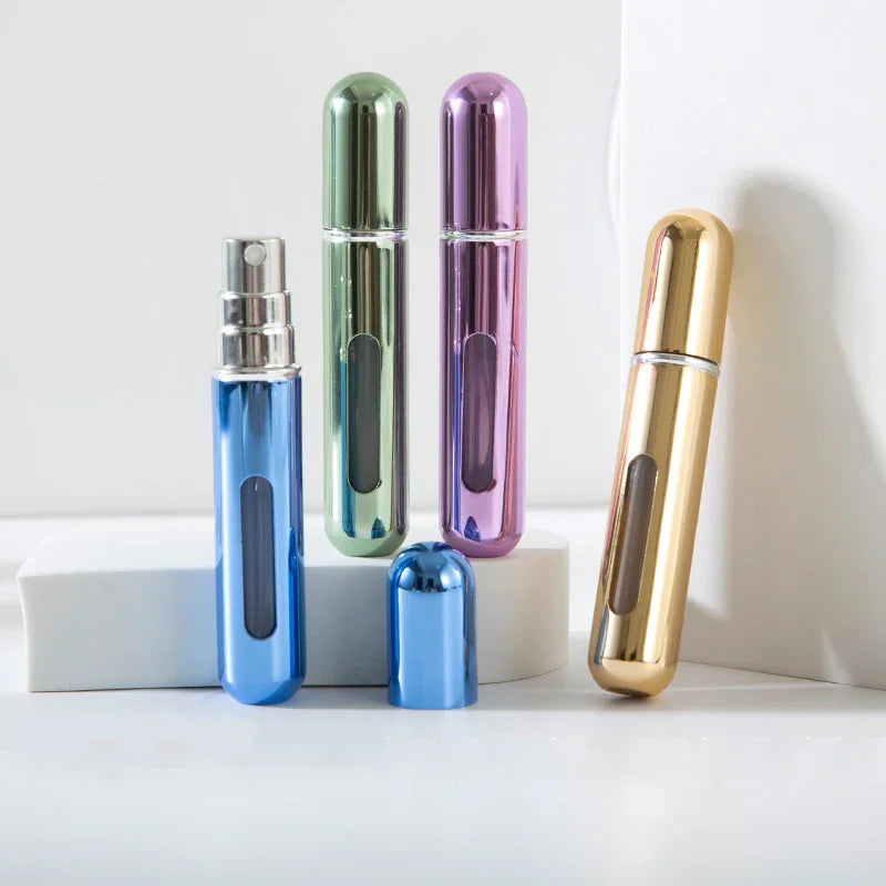 A group of colorful portable perfume atomizer bottles.