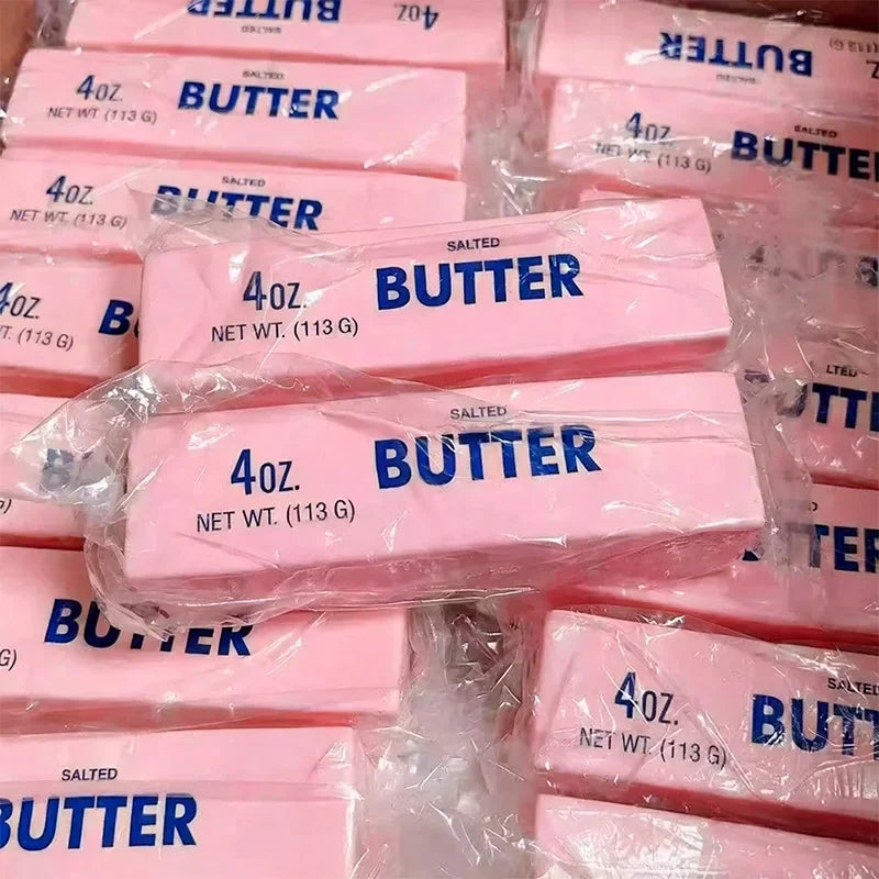 Pile of squishy pink butter stick toys in packaging