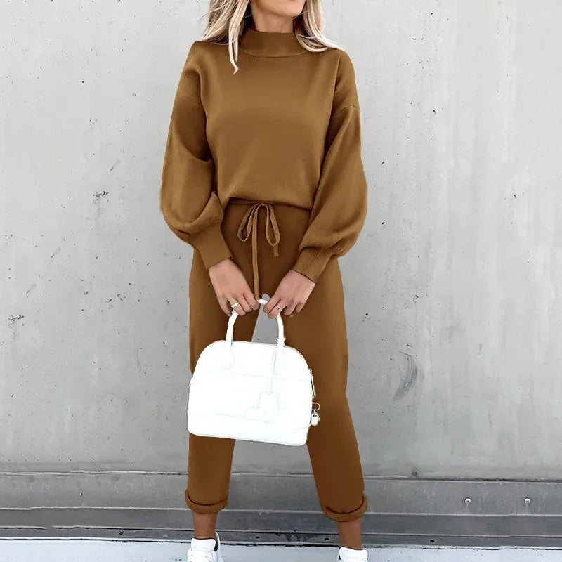 Woman posing in a brown knitted long sleeve pullover and drawstring jogger pant set.
