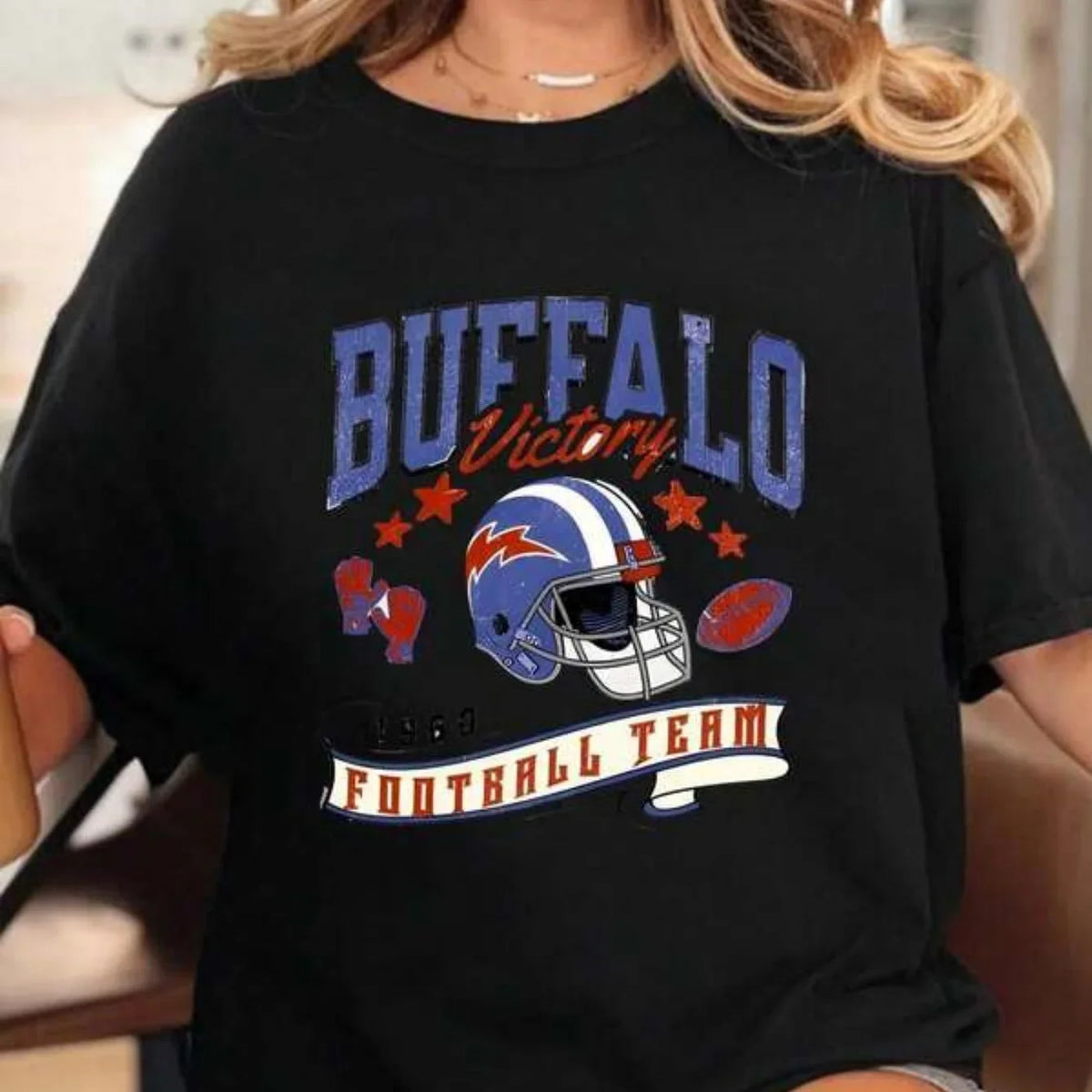 Black unisex cotton t-shirt with vintage style American football graphic print featuring a helmet and team text