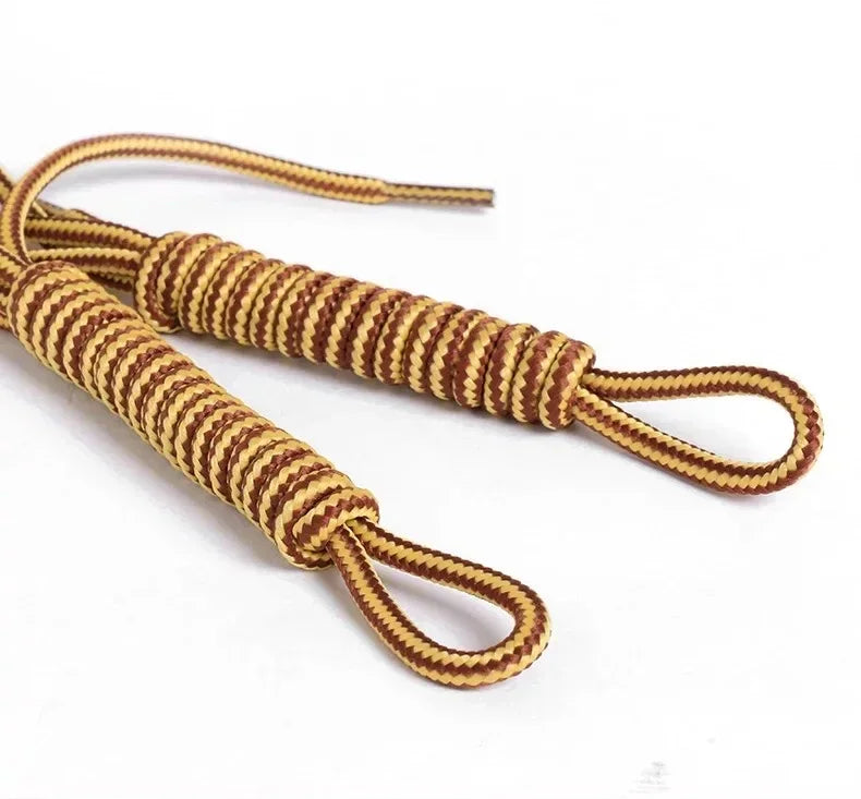 Close up of two brown and yellow striped shoelaces