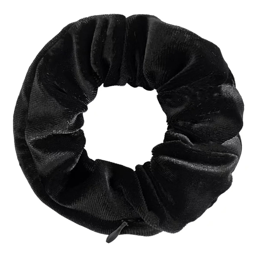 A plain black velvet hair scrunchie with a small hidden zipper closure.