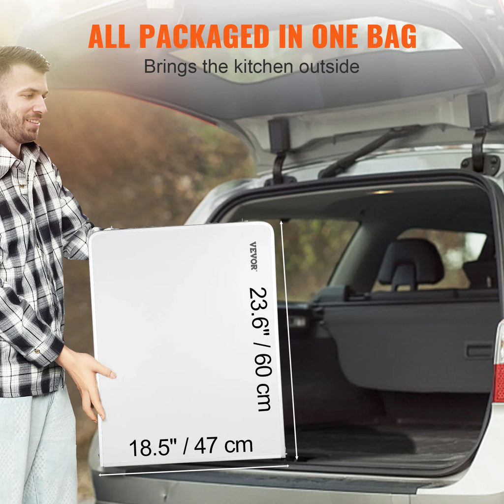 Person holding a folded portable camping table next to the open trunk of a vehicle