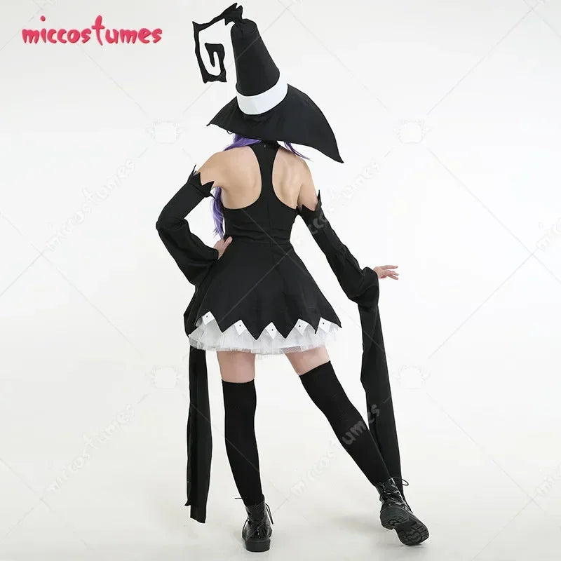 A woman showing the back view of a black witch cosplay dress and large hat