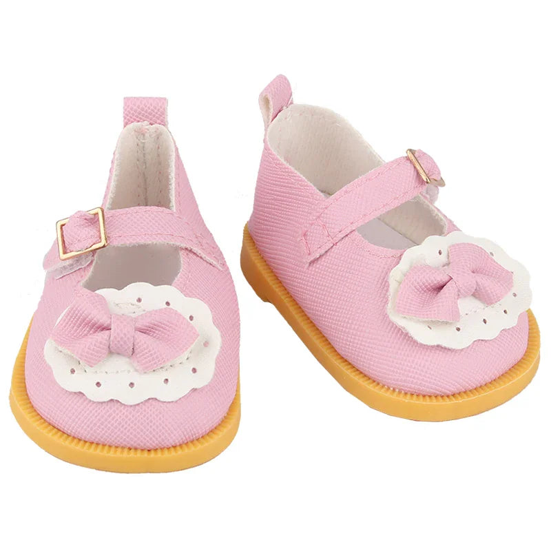 Pink doll shoes with a white scalloped trim and a small pink bow strap
