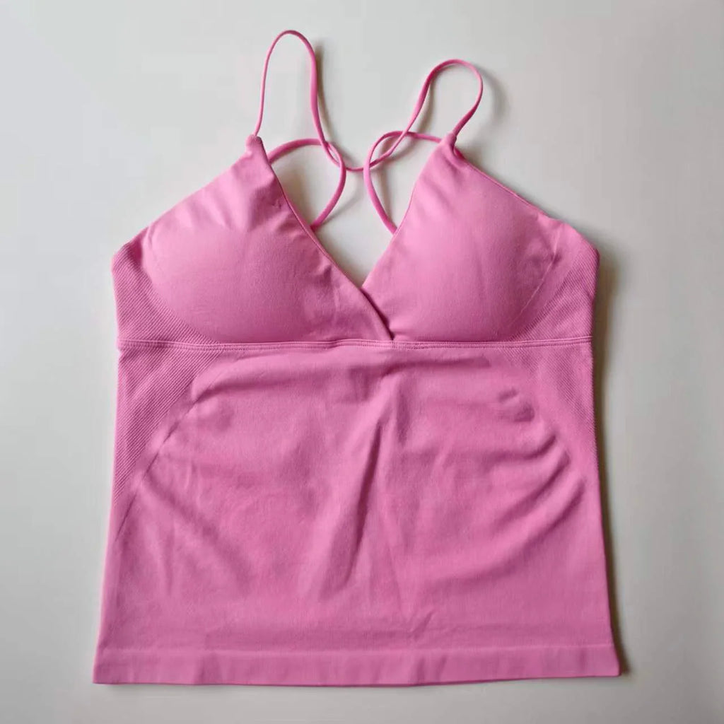 A sleeveless deep-v workout tank top in light pink with thin straps.
