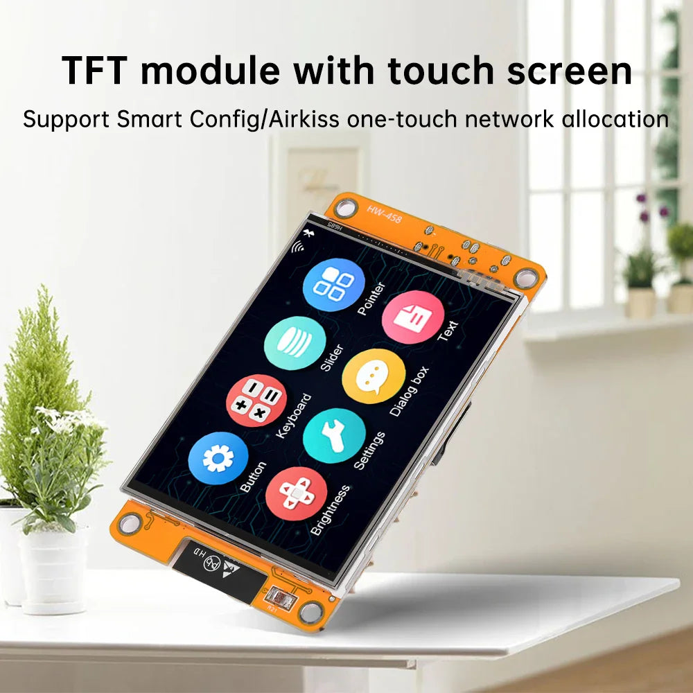 TFT module touch screen development board angled on a table with a small plant