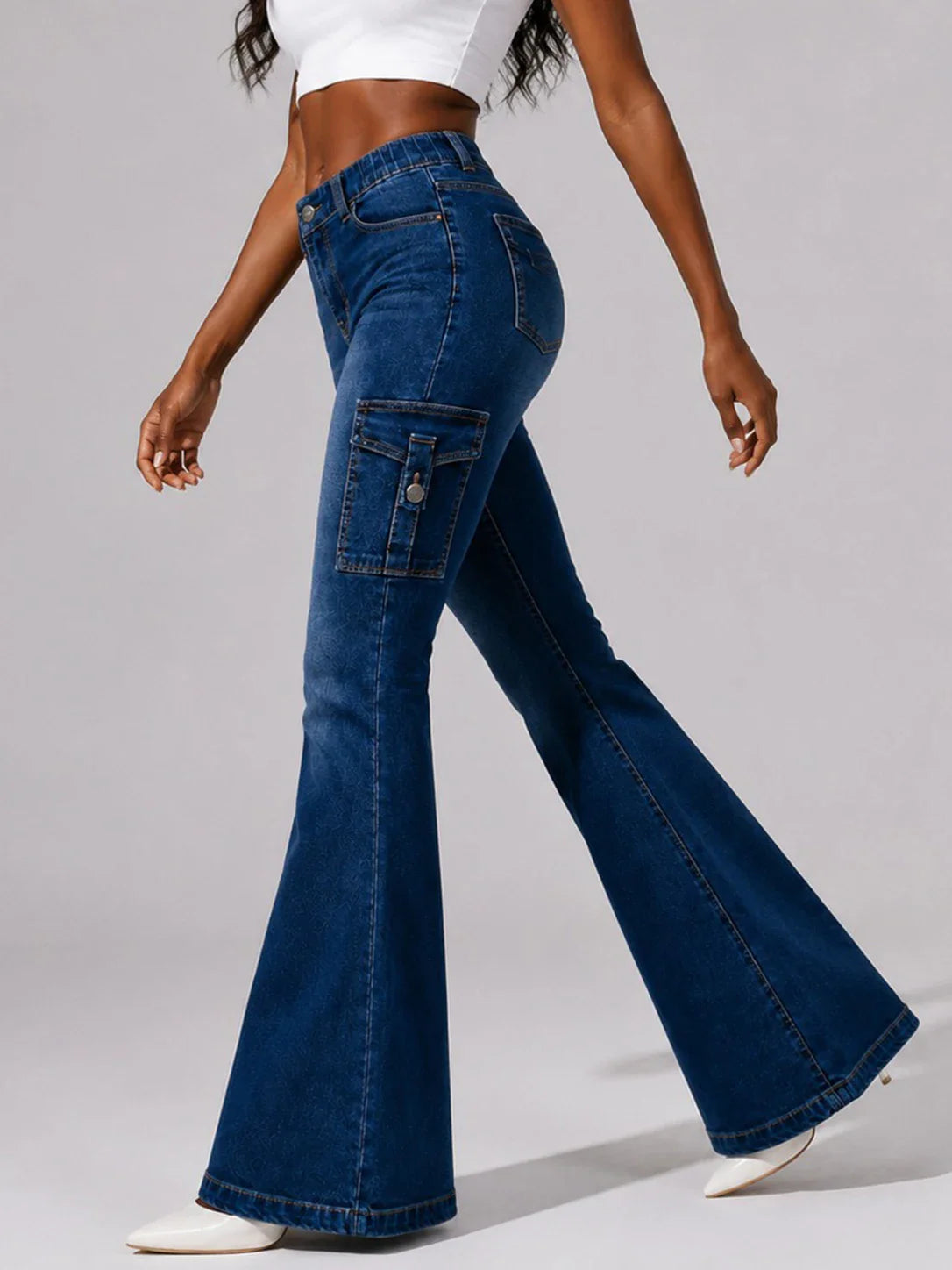 Dark wash blue cargo flare jeans, side view, worn by a model.