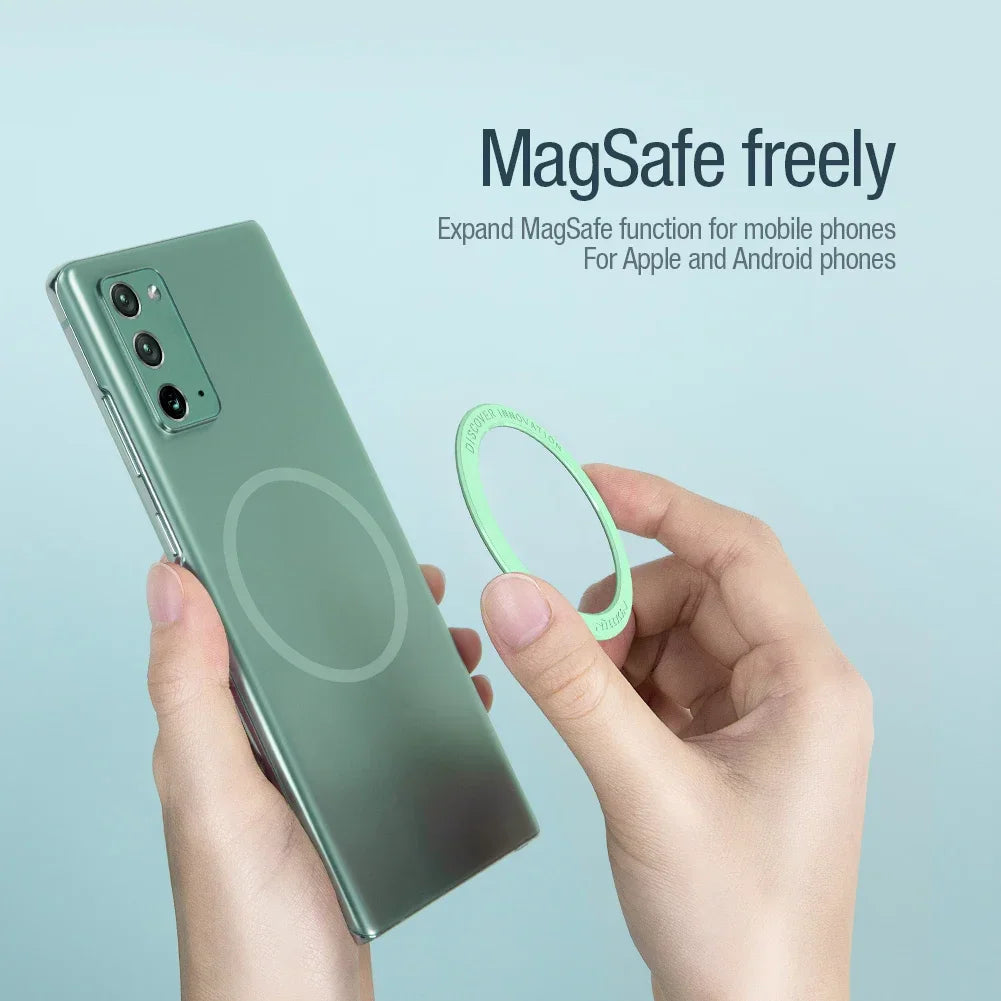 Person attaching a green magnetic ring sticker to the back of a green smartphone