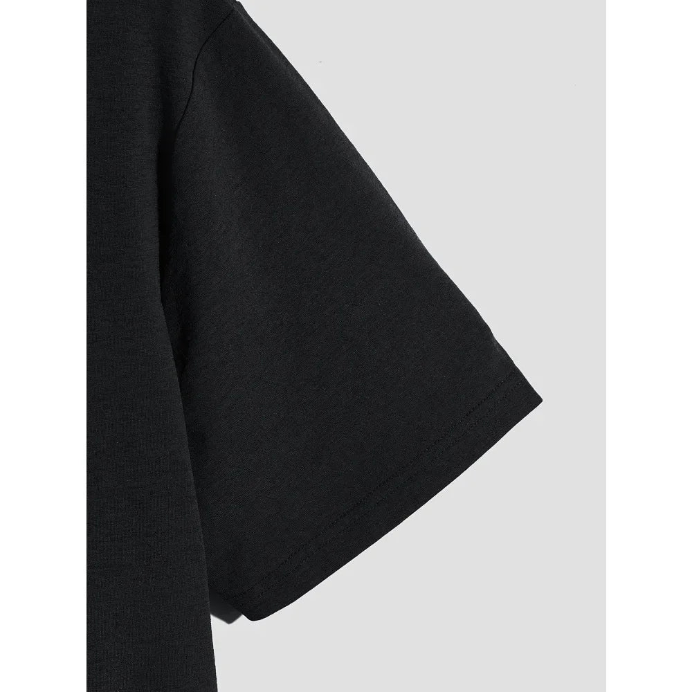 Close up of the sleeve of a black cotton t-shirt