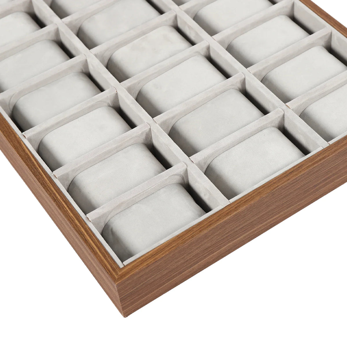 Close-up view of empty grey velvet watch display tray compartments