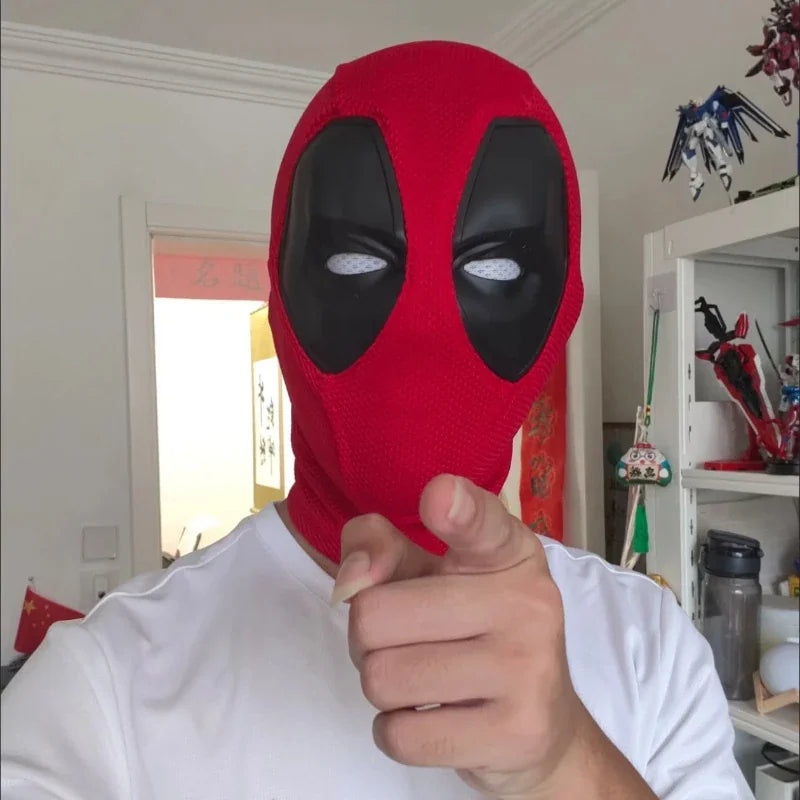 Person wearing a red and black knitted superhero mask