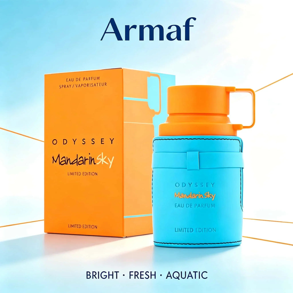 Blue and orange perfume bottle with its packaging box in a bright outdoor setting