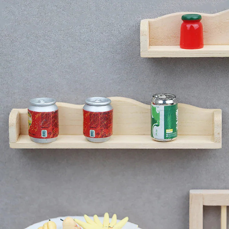 Two miniature wooden dollhouse shelves mounted on a wall with small toy bottles and cans on them.