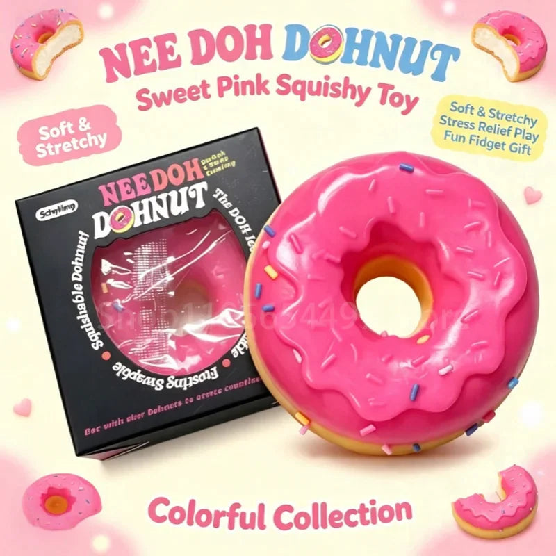 Pink doughnut shaped sensory fidget toy next to its individual black display box.
