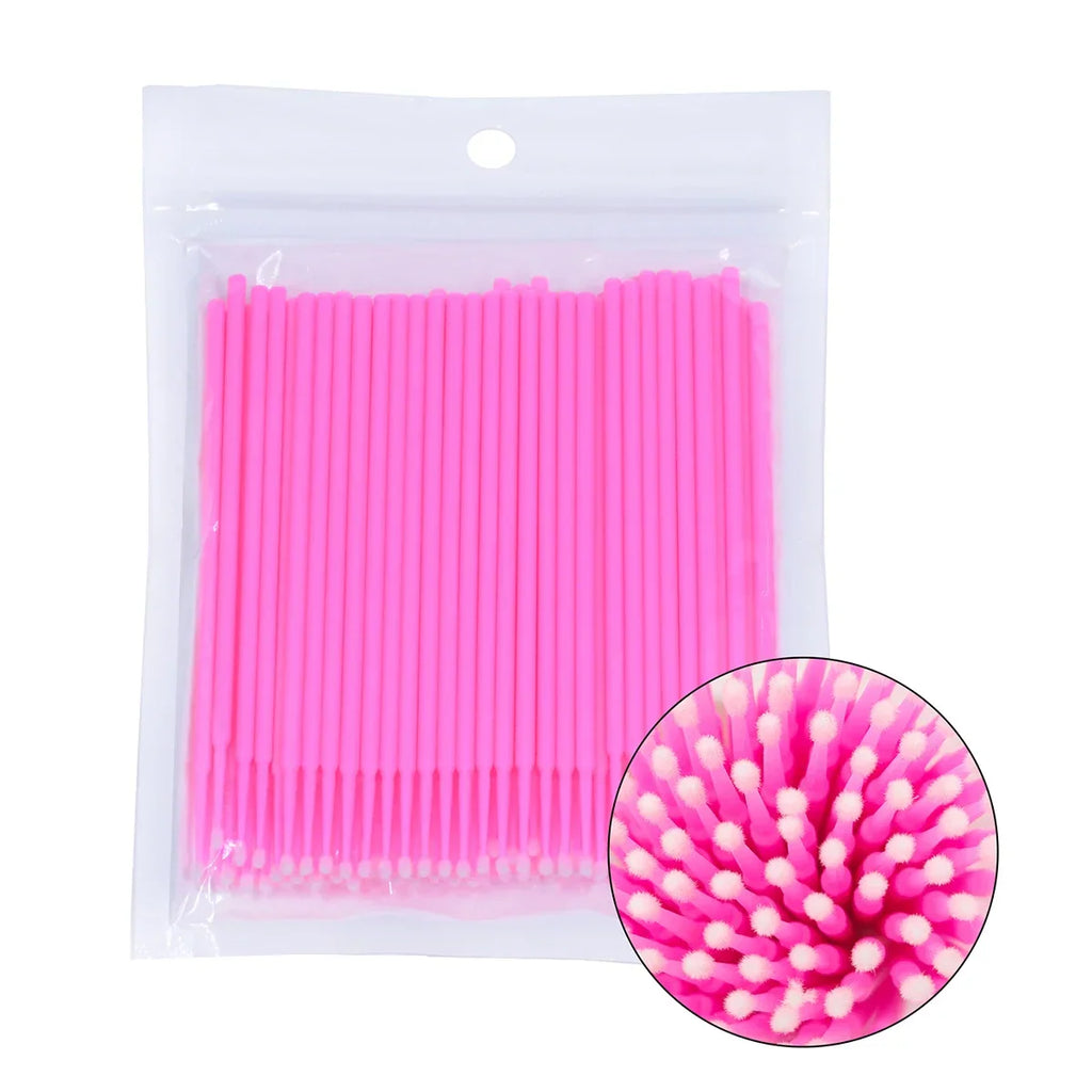 Disposable pink microbrushes in a clear plastic bag with a circular close-up view of the brush tips.
