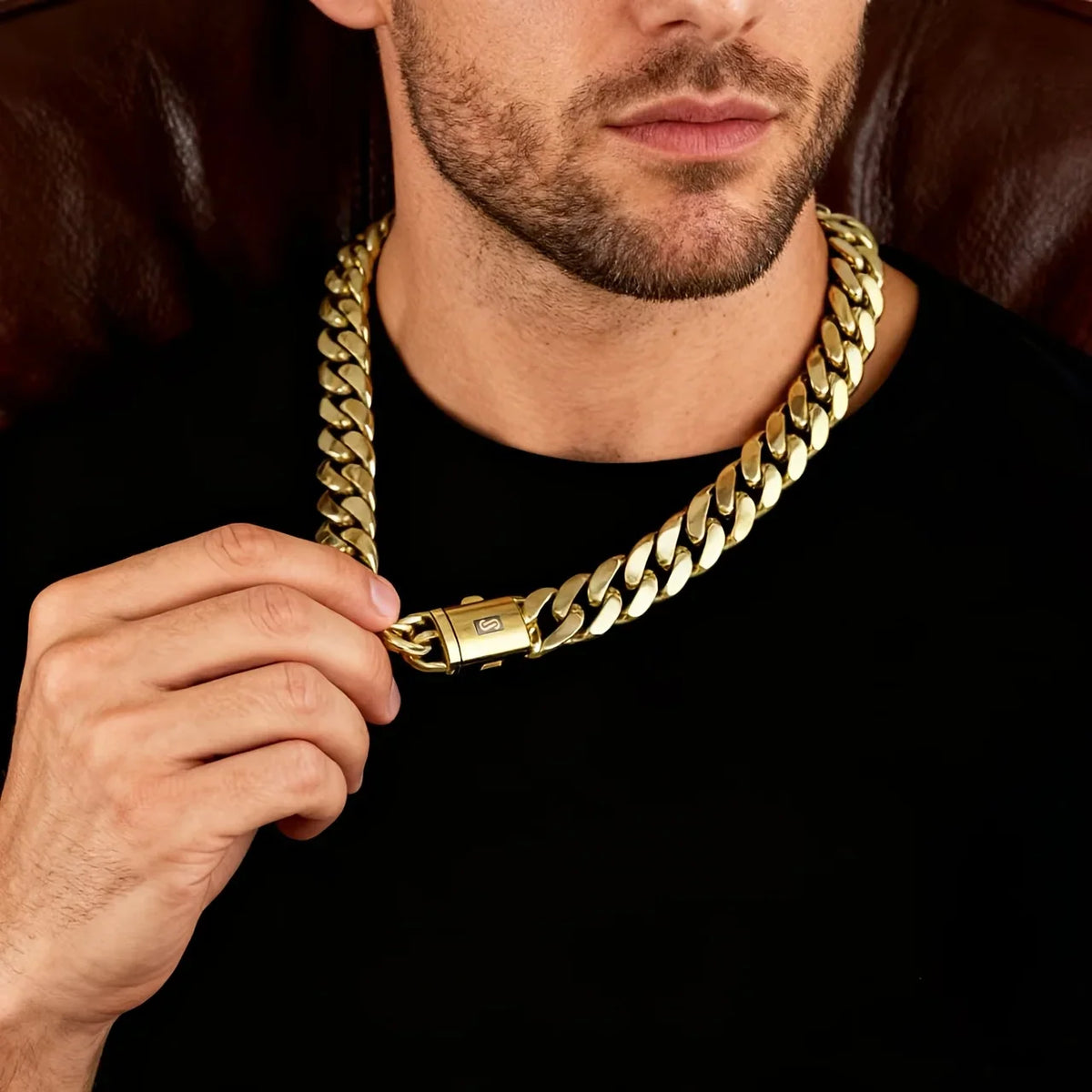 Close-up of a person wearing a thick gold cuban link chain