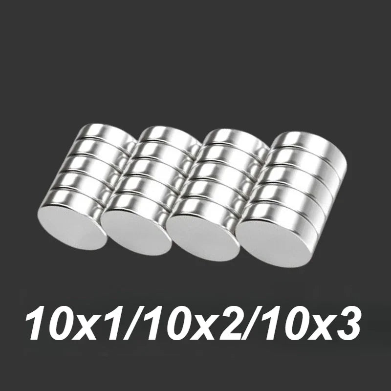 A group of small silver disc magnets in various thicknesses.