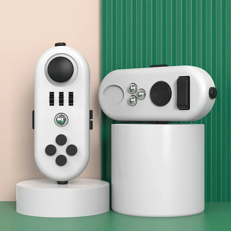 White handheld fidget controller toy with black buttons, rollers, and gears on display pedestals