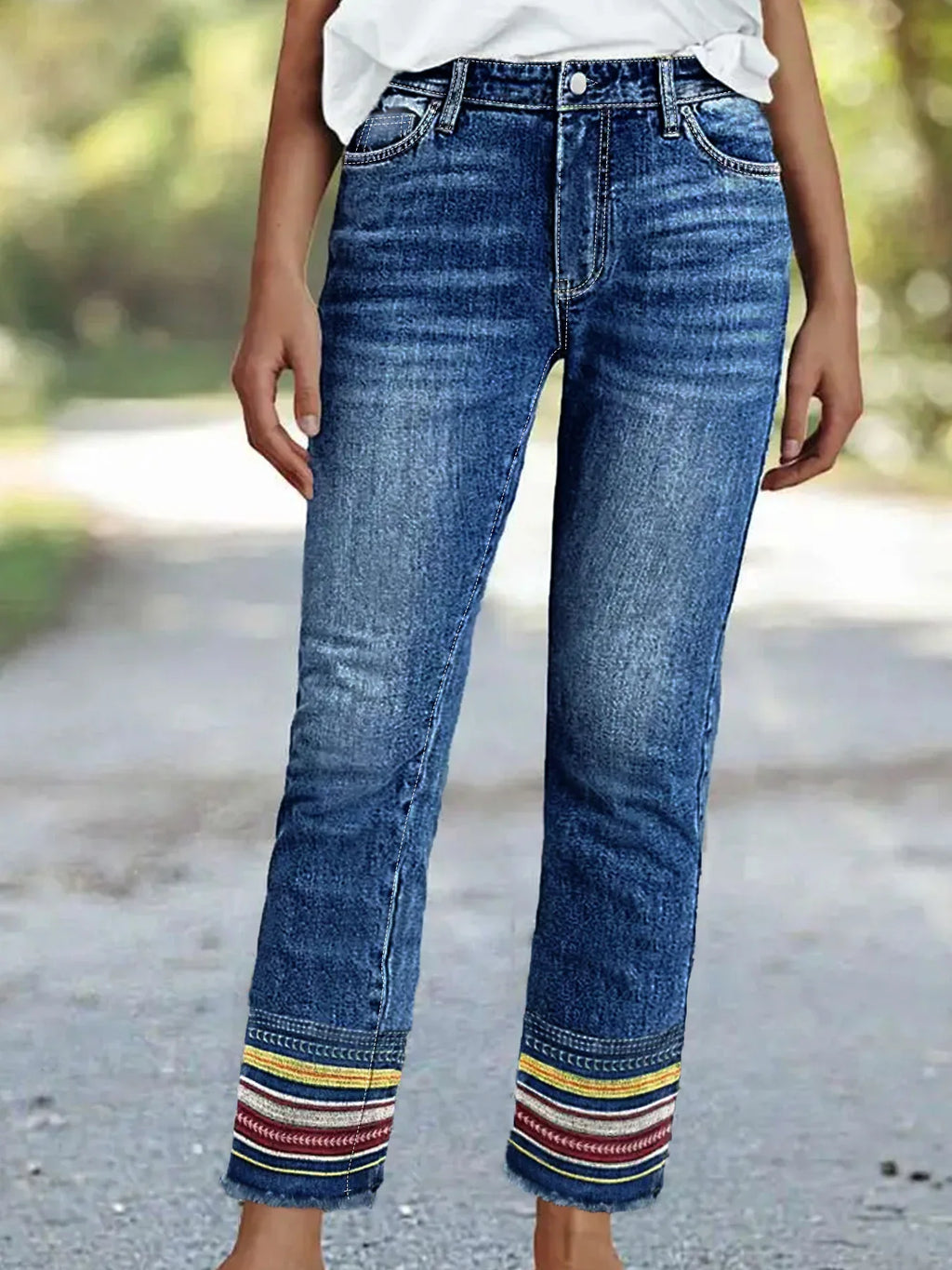 Blue straight leg denim jeans with decorative striped embroidery on cuffs