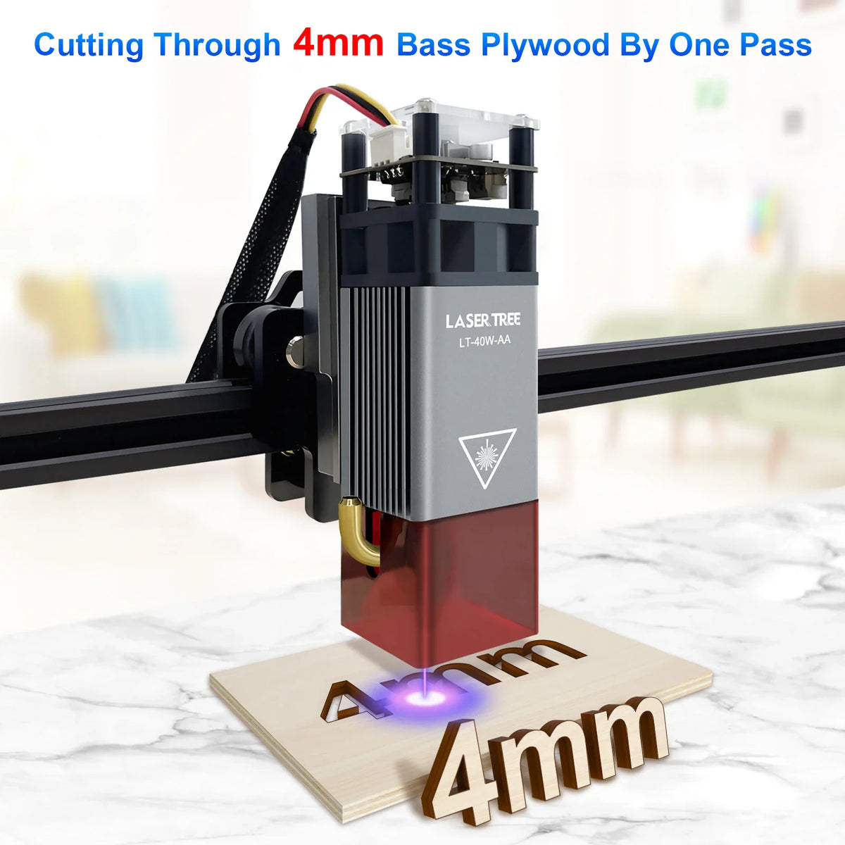 Laser engraving head cutting through plywood sheet