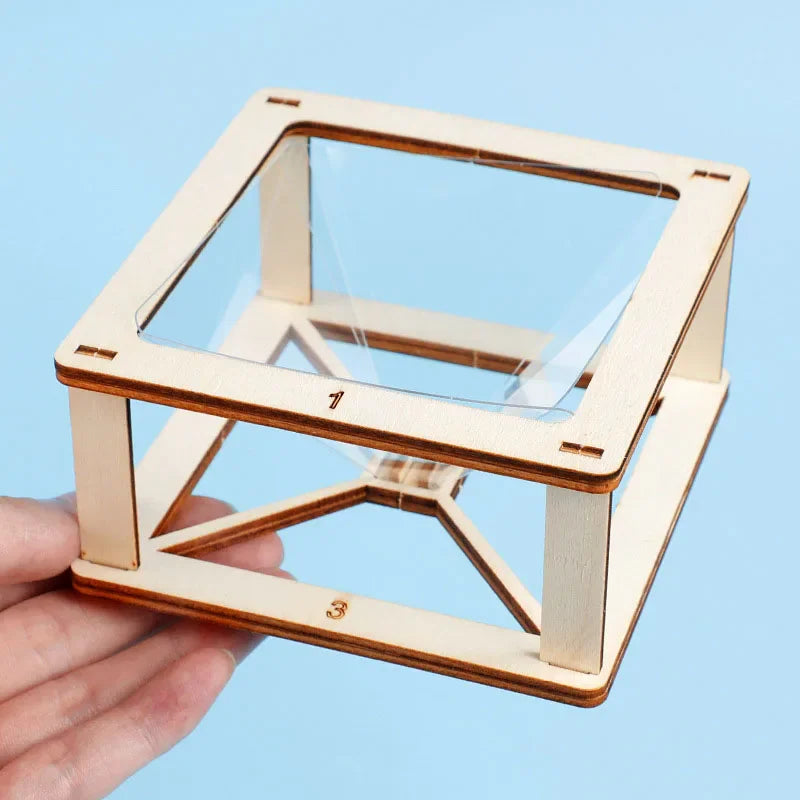 Hand holding a square wooden frame for a DIY 3D holographic pyramid projector