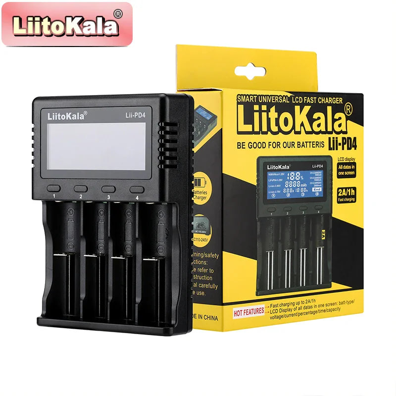 Four-slot universal battery charger next to its retail box packaging