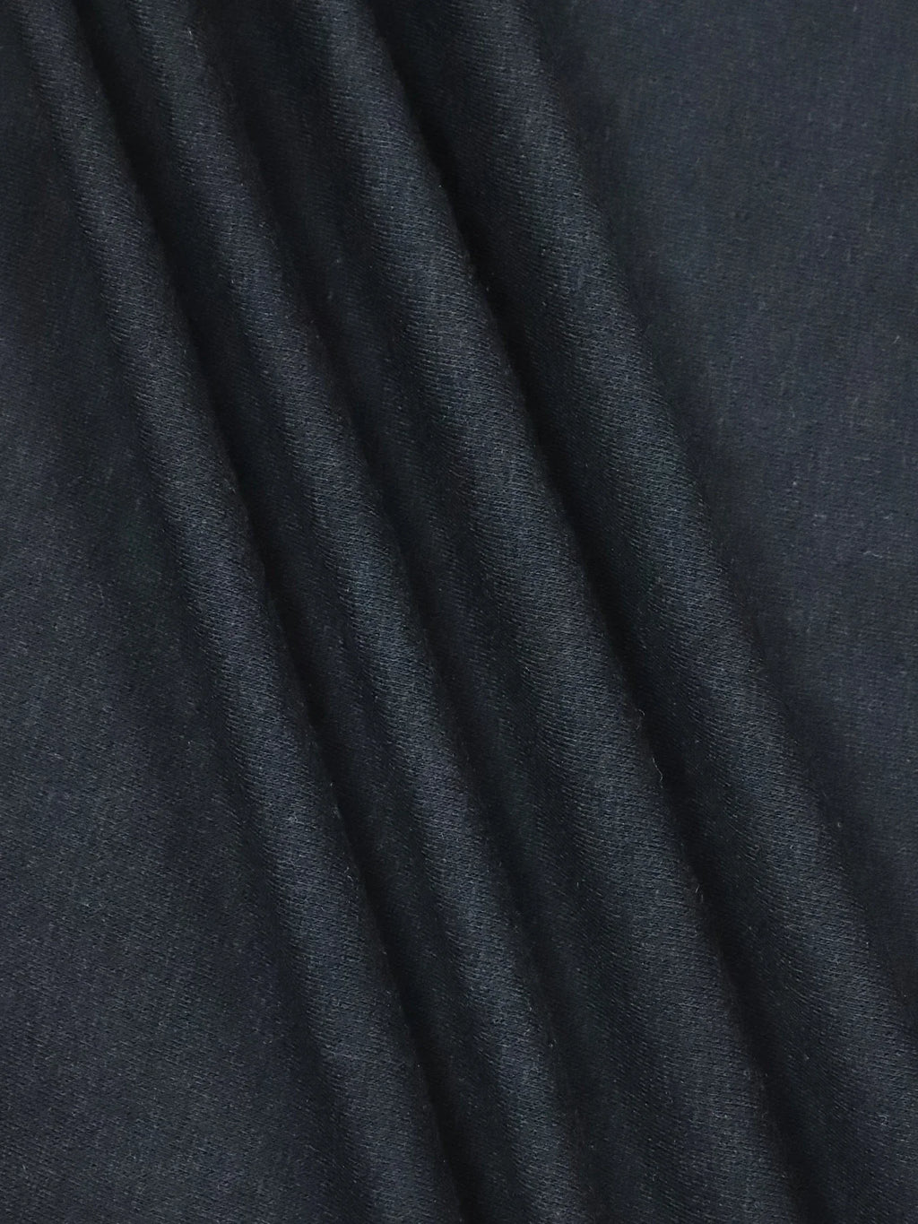 Folded black cotton fabric texture