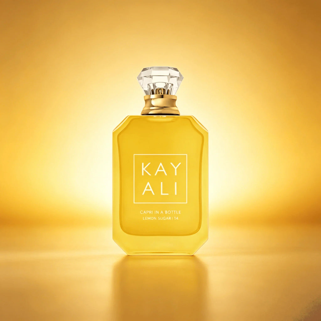 Bottle of lemon sugar scented perfume on a golden yellow background
