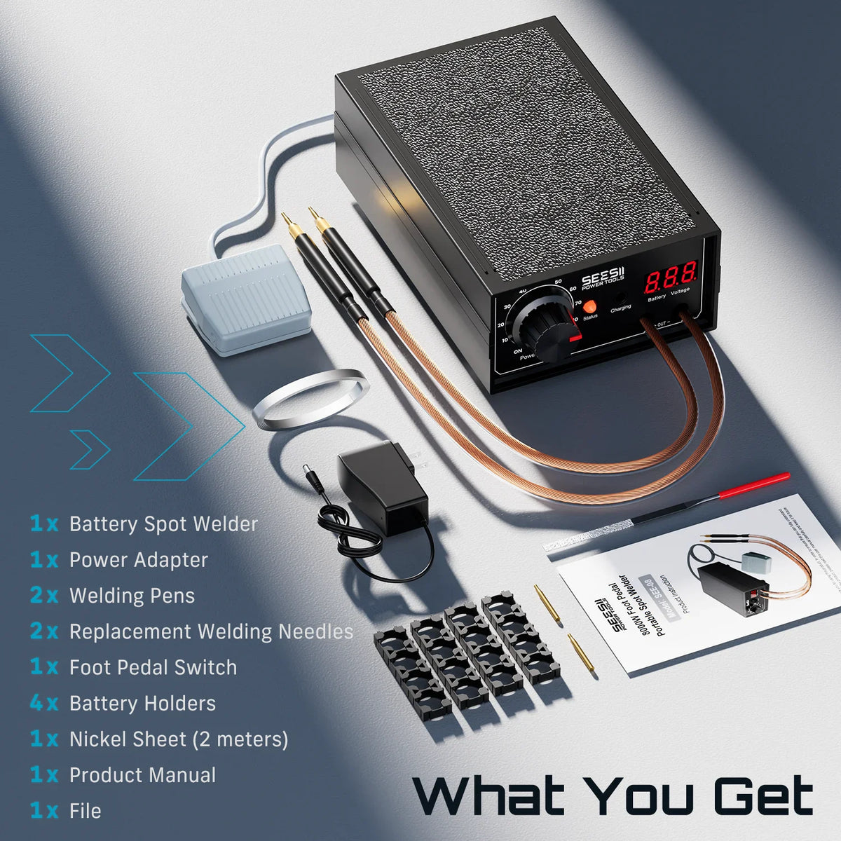 A complete kit of a battery spot welder including the main unit, cables, foot pedal, and various welding supplies.