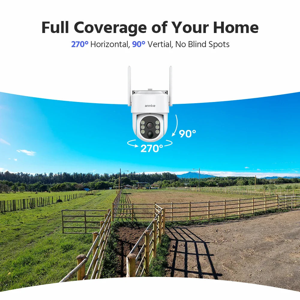 A white wireless outdoor security camera showing a wide viewing angle over a field