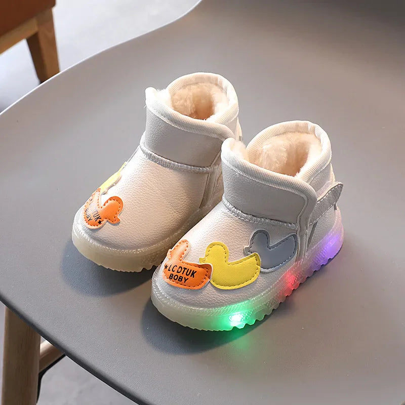 Pair of white toddler winter boots with fleece lining, duck appliques, and light-up soles
