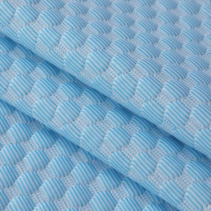 Draped blue and white honeycomb texture fabric close-up