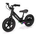 Studio shot of a black electric kids balance bike with colourful LED lights