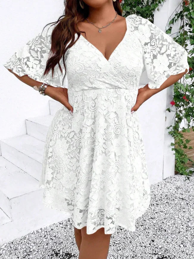 Front view of a white lace mini dress with short flutter sleeves and a V-neckline