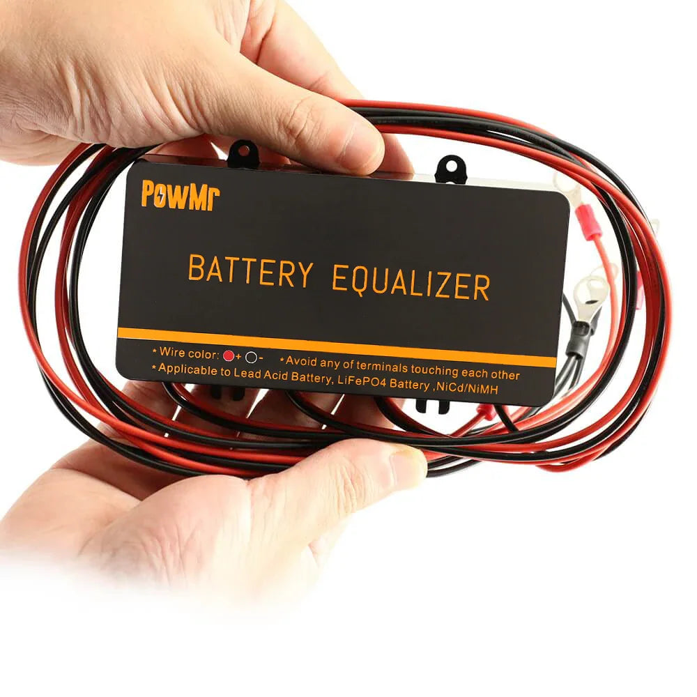 Person holding a black rectangular battery equalizer device