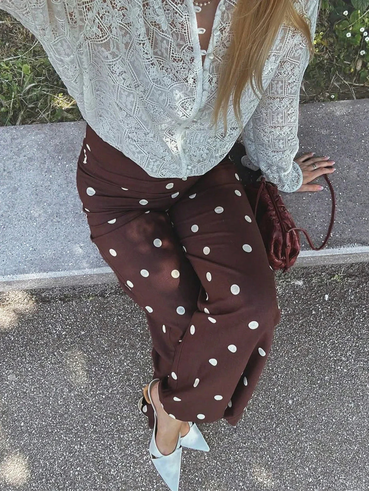 Brown polka dot wide-leg trousers with white lace blouse