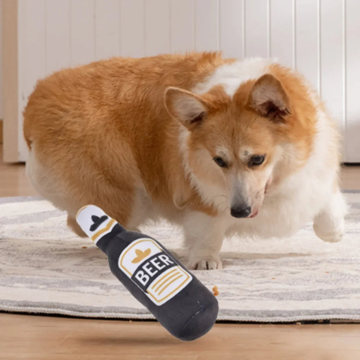 Black plush beer bottle dog toy lying on a carpet near a dog