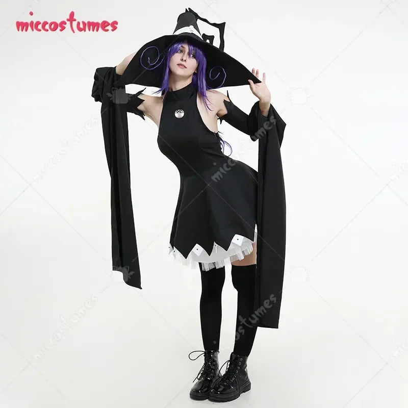 A woman posing in a black witch cosplay dress with a wide-brimmed hat and purple wig
