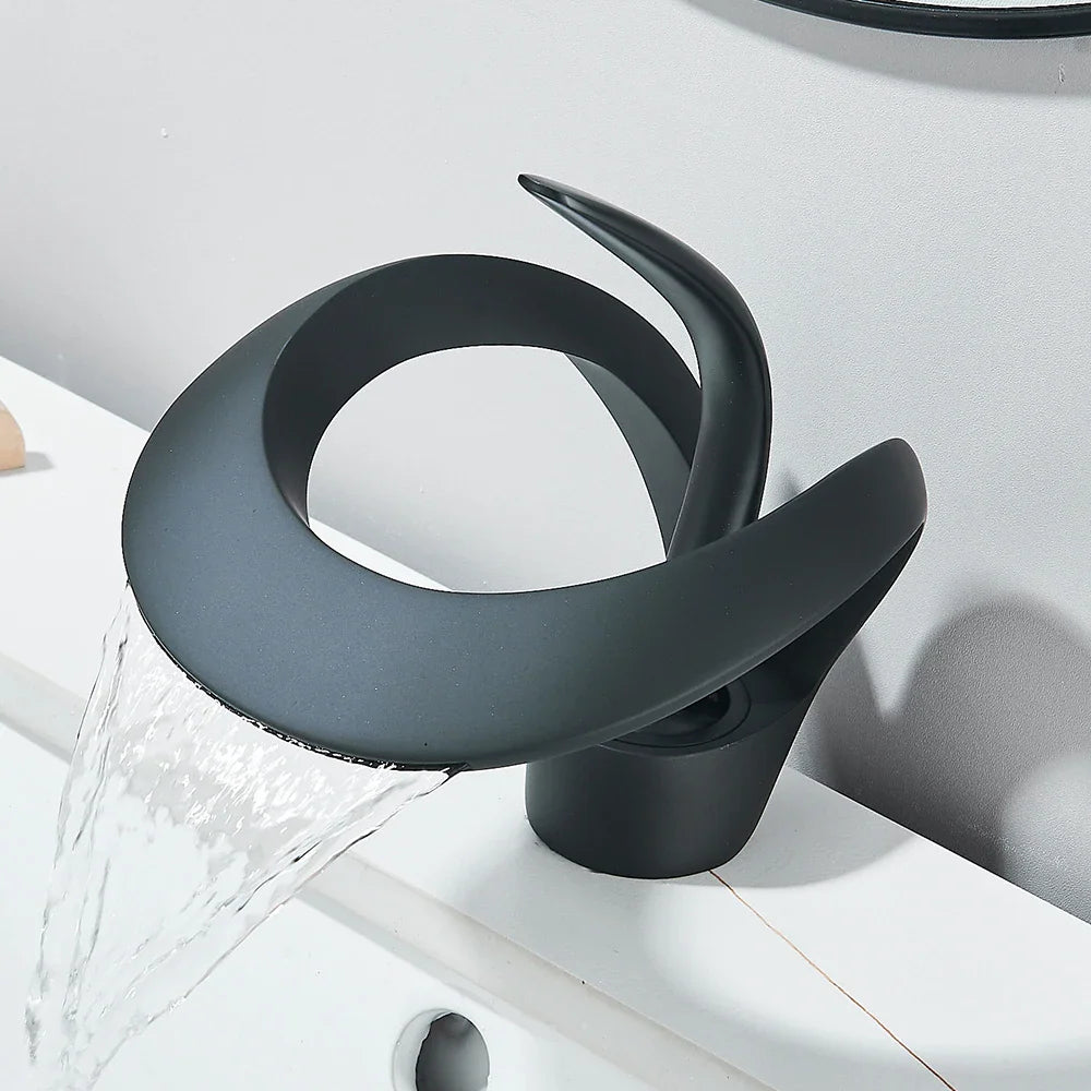 Matte black waterfall basin faucet with flowing water