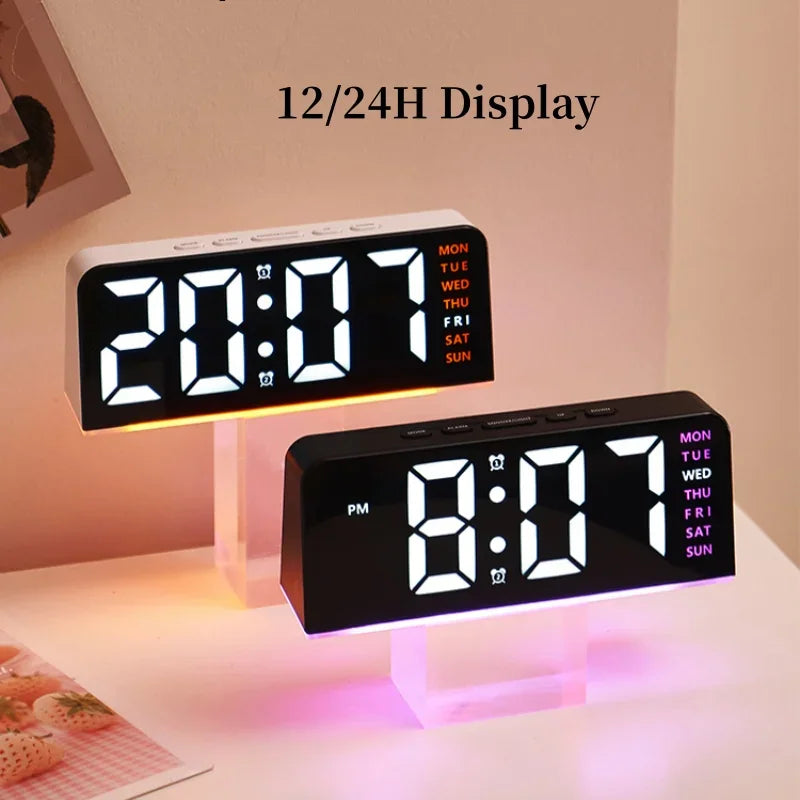 Two digital LED alarm clocks on clear stands comparing 12 and 24 hour display modes