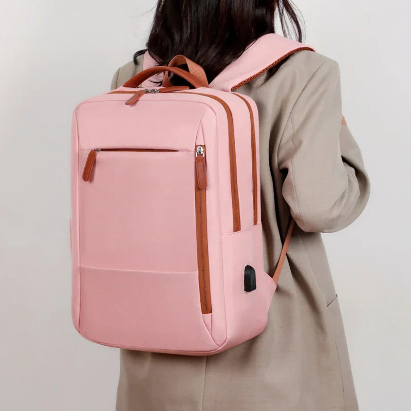 A person wearing a pink laptop backpack with brown accents.