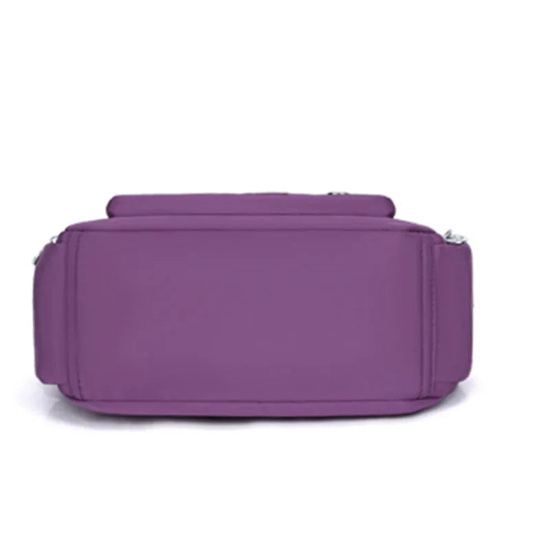 Bottom view of a purple nylon crossbody bag