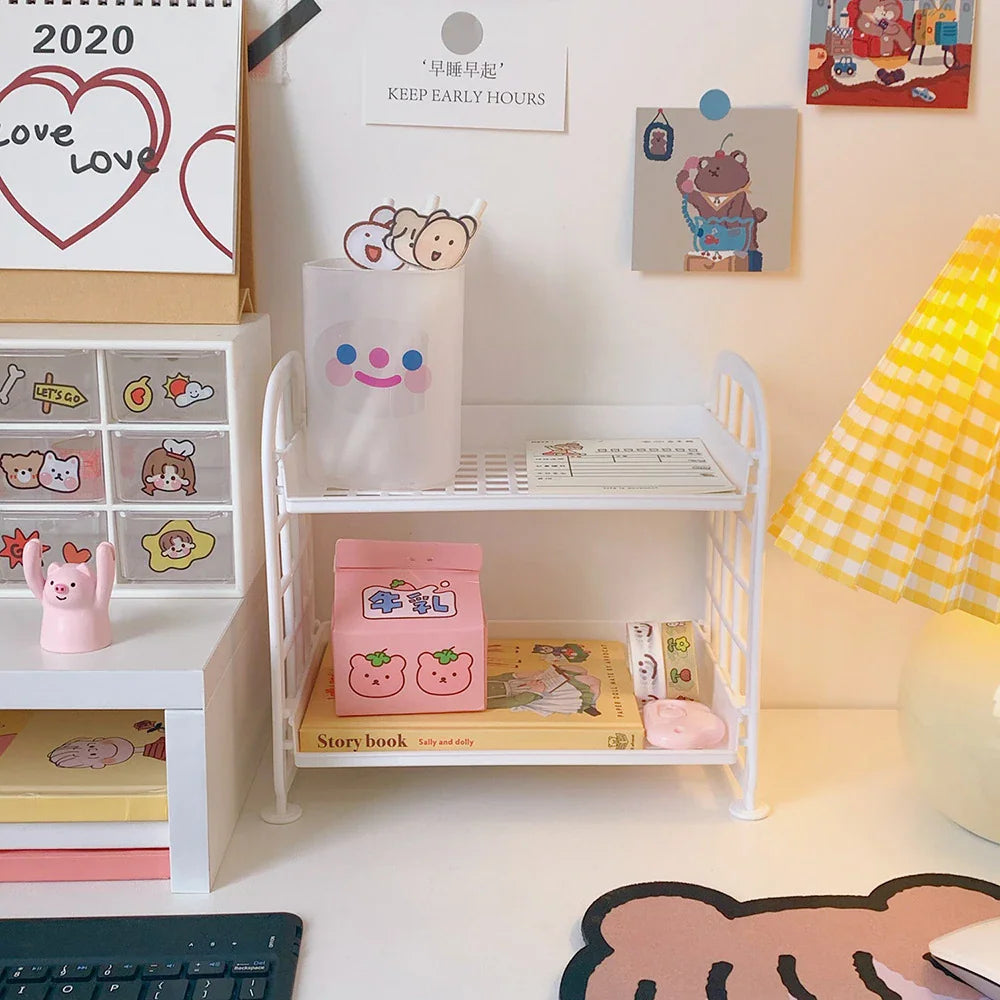 White two-tier plastic desk storage shelf with stationery and decorative items
