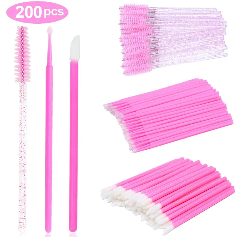 A set of disposable pink eyelash brushes, microbrushes, and lip gloss applicators.