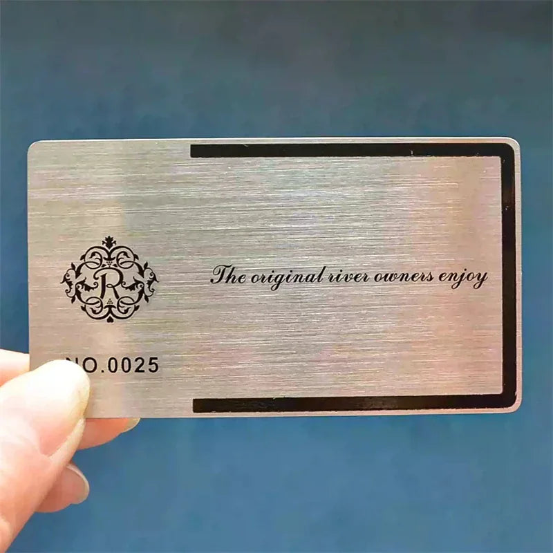 Brushed metal business card with decorative crest and serial number