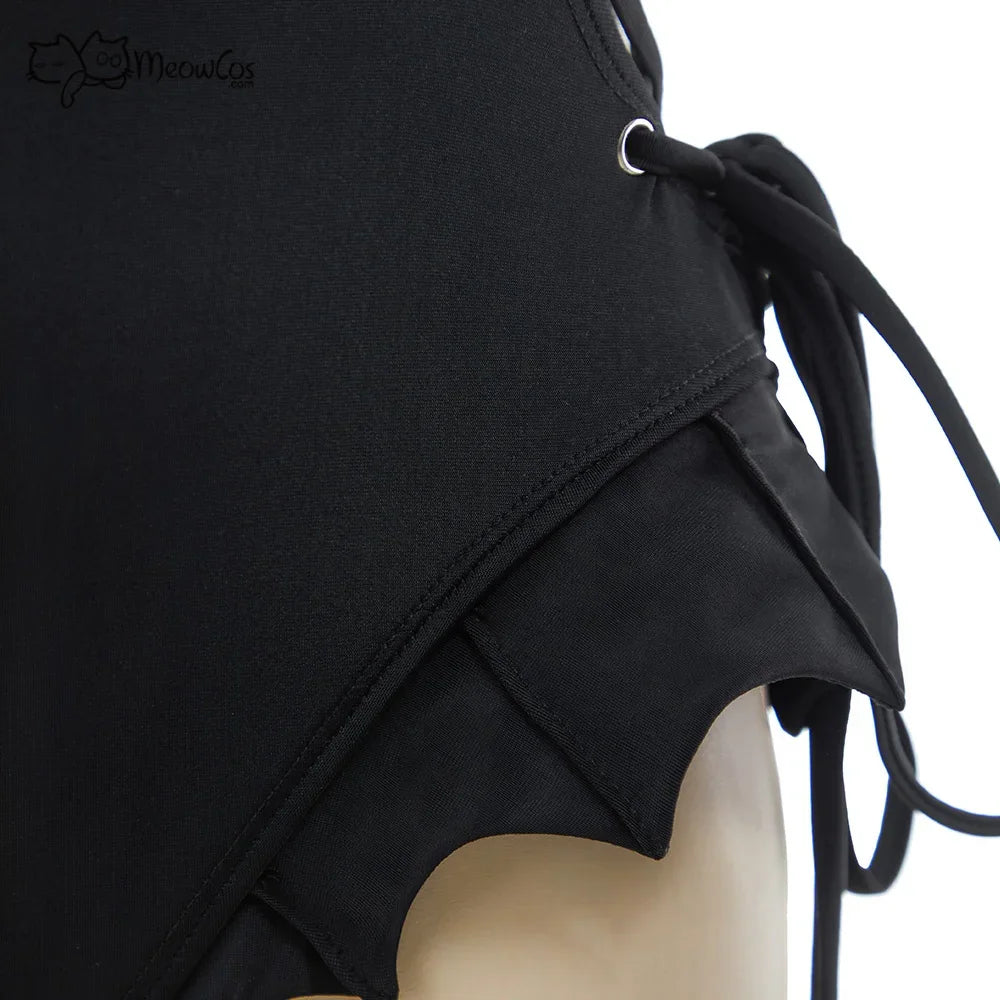 Close-up of the lace-up side and bat wing hem detail on a black swimsuit