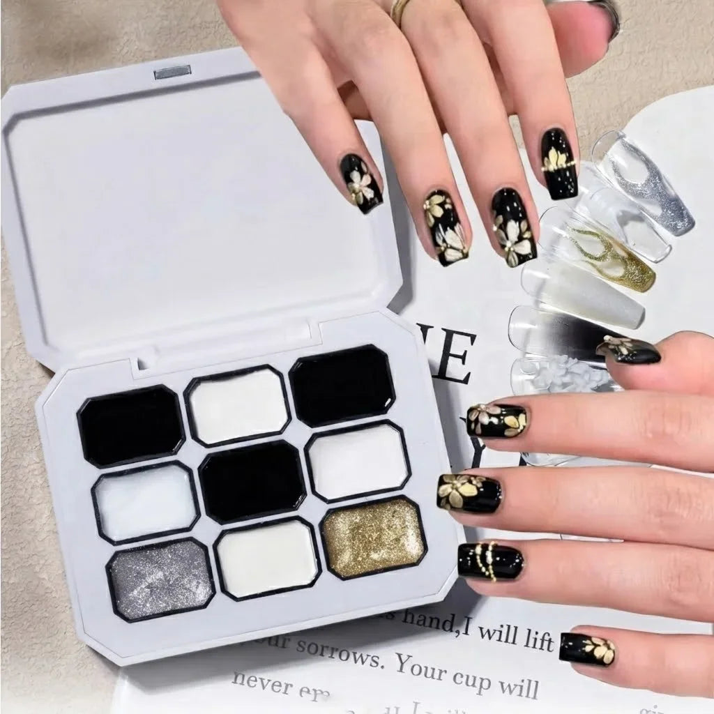 A solid gel nail polish palette with nine colors alongside hands showing various black, white, and gold nail art designs.