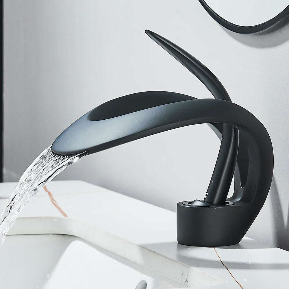 Modern matte black waterfall basin faucet with flowing water